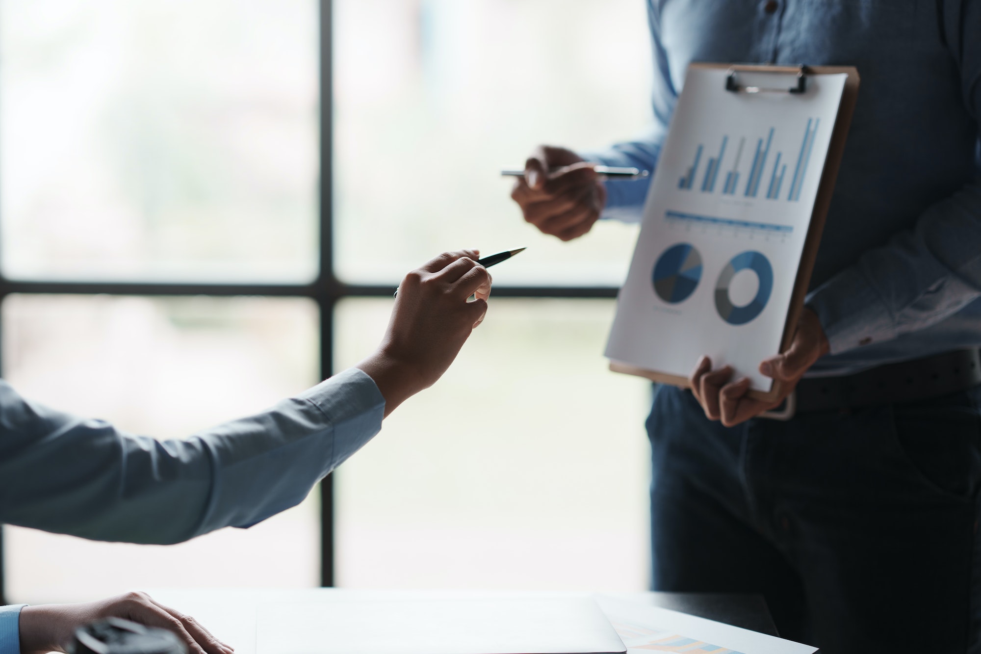 Business team jointly plan the investment at the meeting. Close-up of a business advisor pointing to